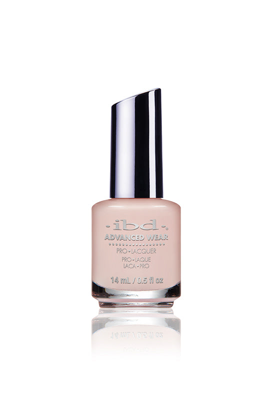 IBD Advanced Wear polish in Beauty Sleep, a soft peachy nude with warm undertones for a classic, feminine manicure.