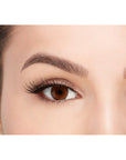 A model wearing Ardell's Faux mink 811 with open right eye showing its finely tapered end & the flared, winged out style