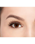 Front view of a model with one eye open wearing Ardell's Fauxmink Wispies to show how they look on the eye