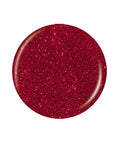 Sample swatch dro[ of a red glitter polish in circle shape