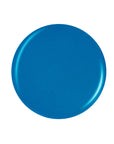 Deep neon blue color nail lacquer sample color drop in round shape isolated in white setting