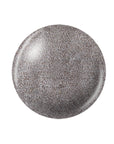 A shimmering silver color of a round shape nail lacquer sample color swatch drop in white background