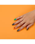 A woman's hand featuring a China Glaze Nail polish and Art Ghoulish on it's nail