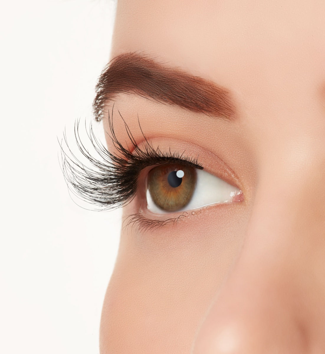 A close-up side shot of a model's eye wearing Ardell's Wispies 703 creating a natural, round light flared eyelash look