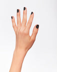 A woman's hand with black glittered nail color