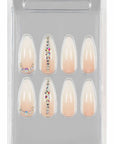Packaged nude gradient press-on nails with rhinestone details, neatly arranged for an elegant and natural look.