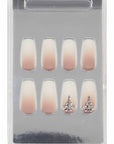Ombré gradient press-on nails with rhinestone embellishments, neatly packaged in a clear display case.