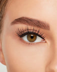 A model wearing Ardell's Double Up 207 with open right eye showing its extra-long layers with intense volume & fullness lash
