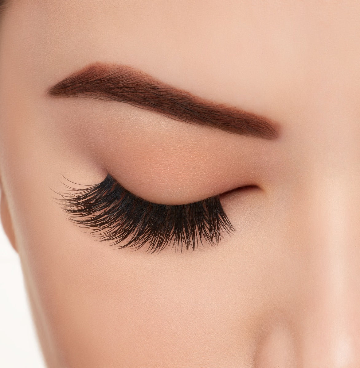 A model's closed right eye wearing Ardell Mega Volume 263 faux lashes