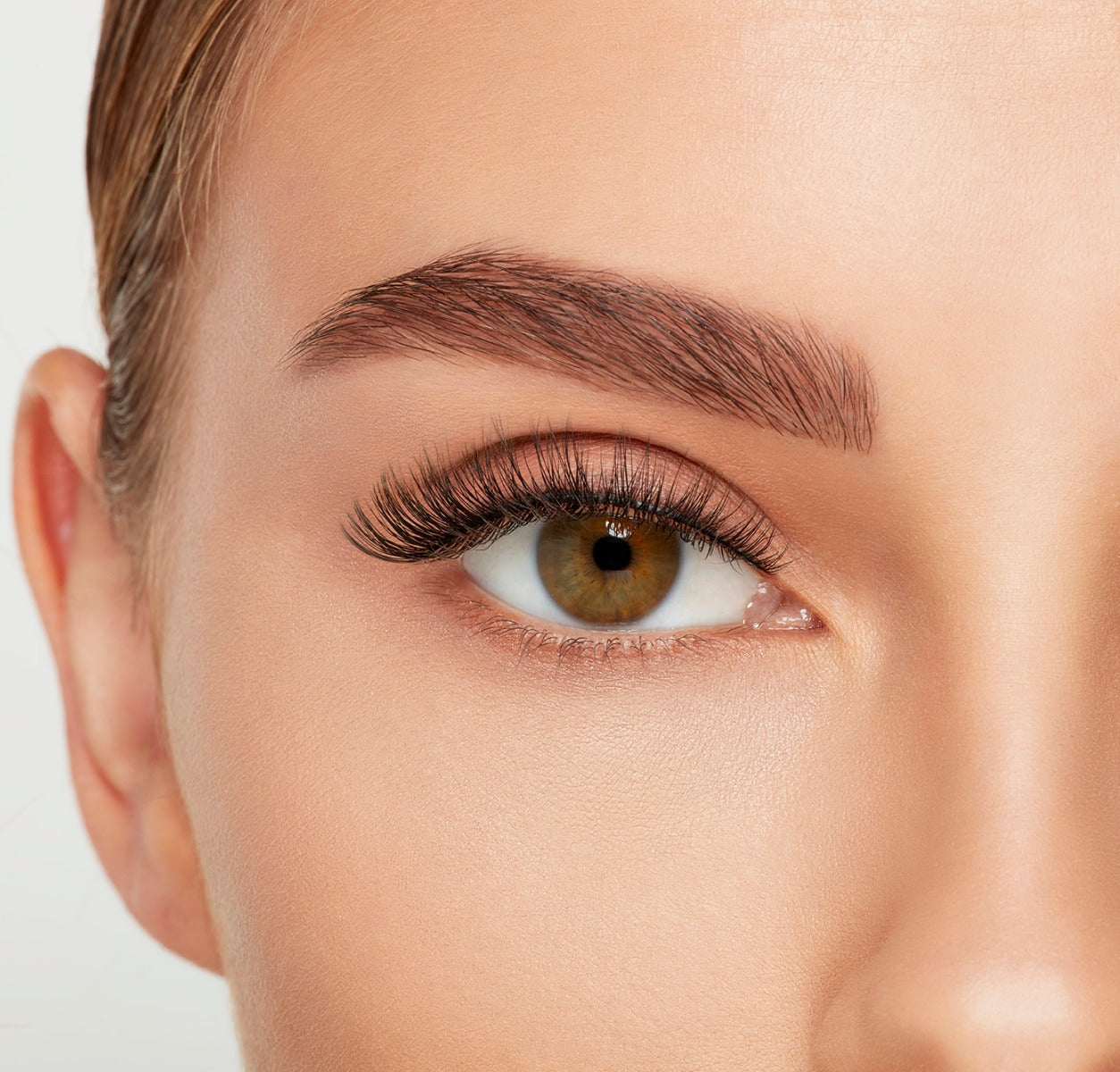 Close-up of a model's open right eye wearing an Ardell Lift Effect 741 false lash showing its upswept contours