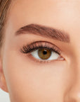 Close-up of a model's open right eye wearing an Ardell Lift Effect 741 false lash showing its upswept contours