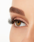 Angled close-up of a model's open right eye wearing an Ardell Lift Effect 741 faux lash