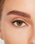 Close-up of a model's open right eye wearing an Ardell Lift Effect 744 false lash showing its airy elongated style