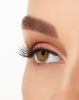 Angled close-up of a model's open right eye wearing an Ardell Lift Effect 744 faux lash