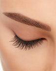 Close-up of a model's closed right eye wearing an Ardell Lift Effect 744 faux lash