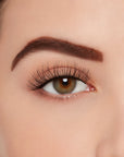 A model wearing Ardell's Ecolashes 451 with open right eye showing its extra-long layers with medium volume & fullness lash