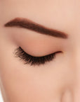 A model wearing Ardell's Ecolashes 451 with close right eye showing its extra-long layers with intense volume & fullness lash
