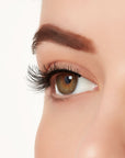 An extreme side close up shot of a model's eye wearing Ardell's Ecolashes 451 creating natural, round flared eyelash