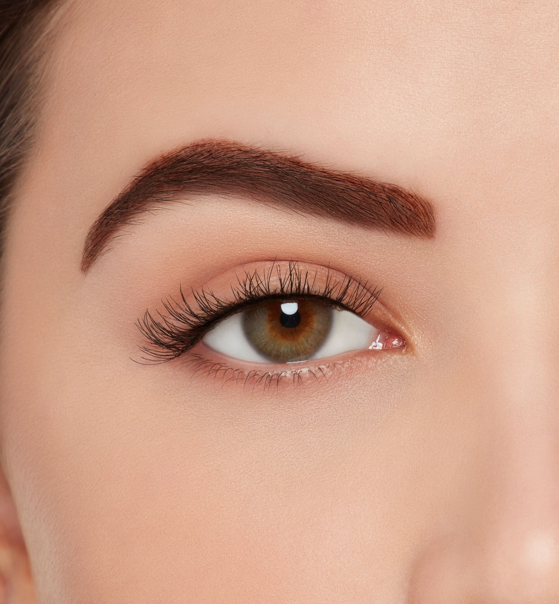 A model wearing Ardell's Ecolashes 453 showing its extra-long fibers, a medium volume for a full lash