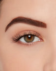 A model wearing Ardell's Ecolashes 453 showing its extra-long fibers, a medium volume for a full lash