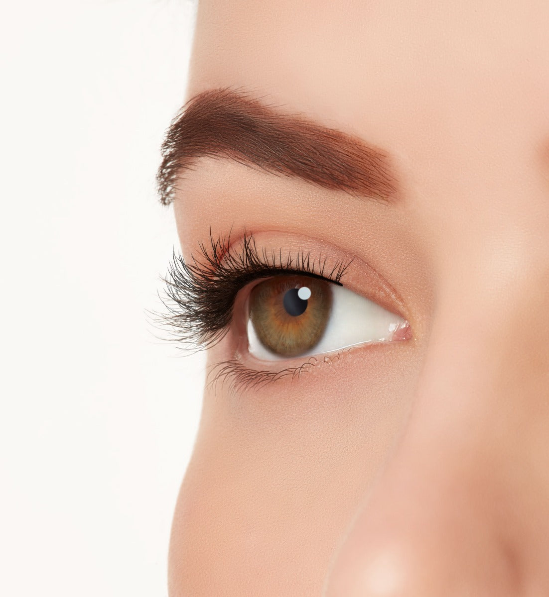 A close-up side-shot of a model's eye wearing Ardell's Ecolashes 453 creating a natural, round flared eyelash