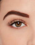 A model wearing Ardell's Ecolashes 454 to show its extra-long, medium volume lash design