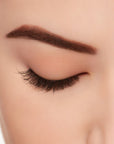 A model wearing Ardell's Ecolashes 454 with close right eye showing its extra-long layers with intense volume & fullness lash