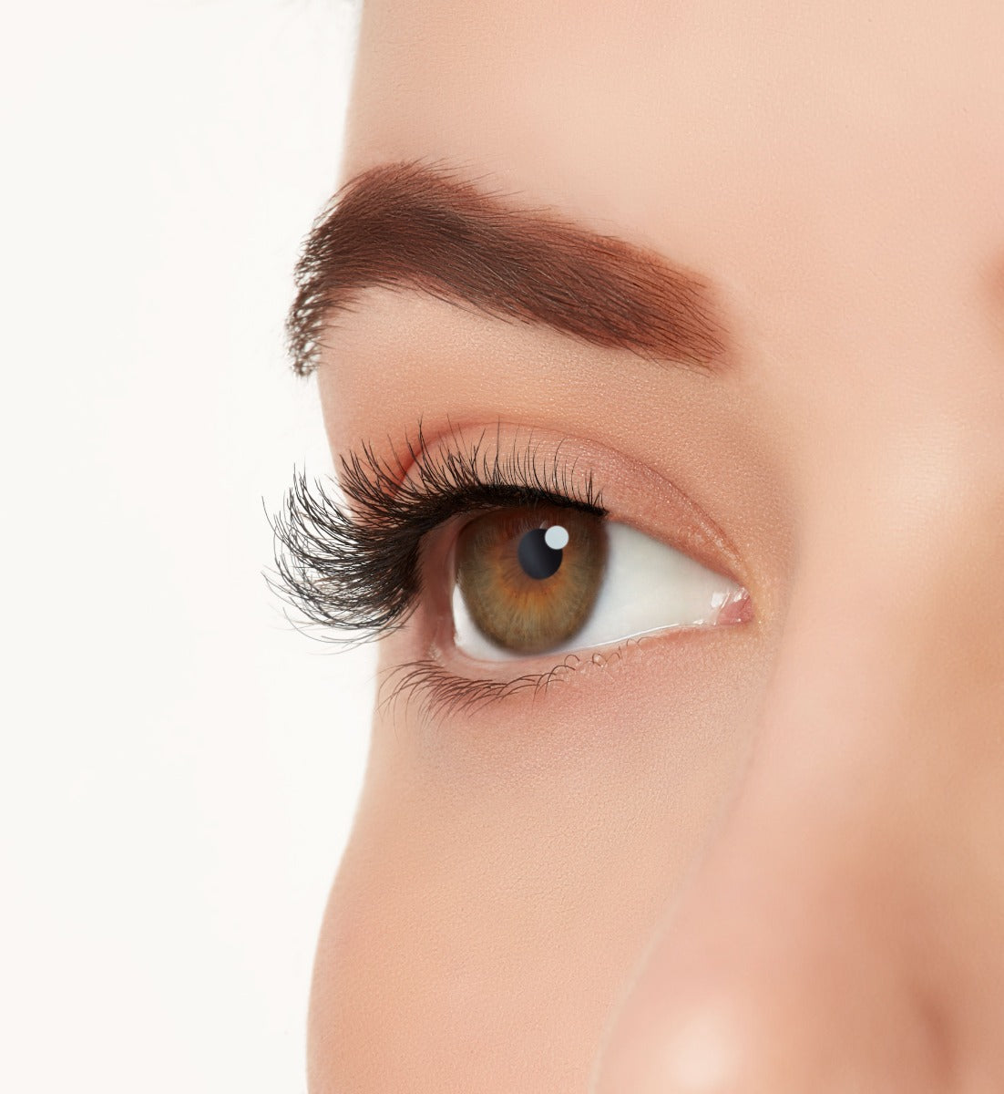 A side shot of a model's eye wearing Ardell's Eco Lashes 454, with natural tapered fibers contour