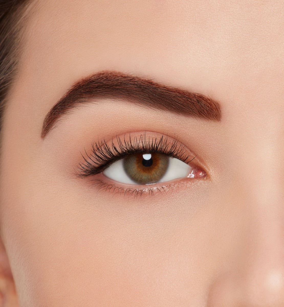 A model wearing Ardell's Eco Lashes 455 with medium volume & length, round shape features