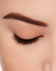 Ardell's Ecolashes 455 on a closed right eye to show its extra-long, intense volume full lash look.