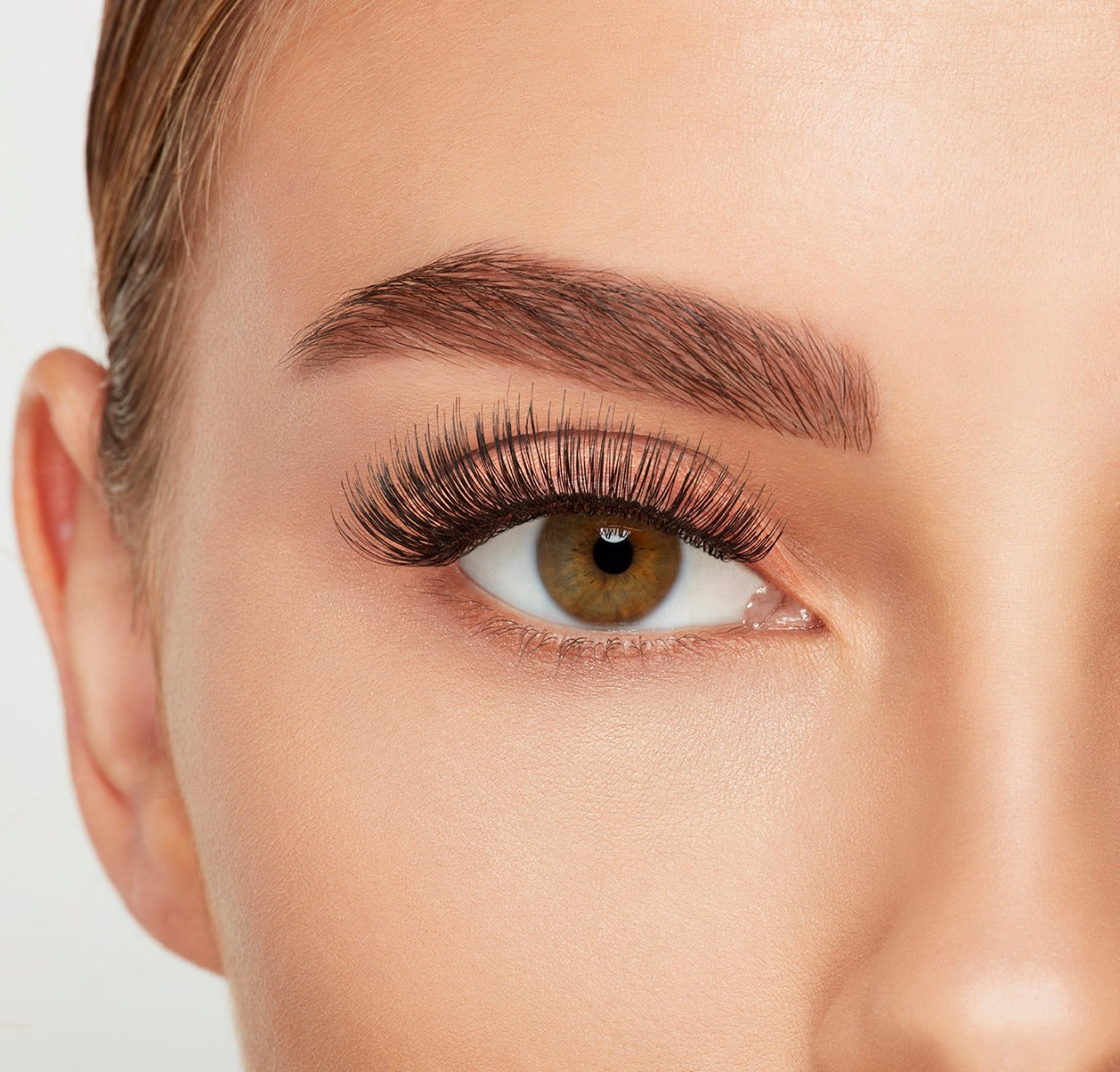 A model with an open eye wearing Ardell Studio Effects 105 showing its flared, long, curly & natural lash look