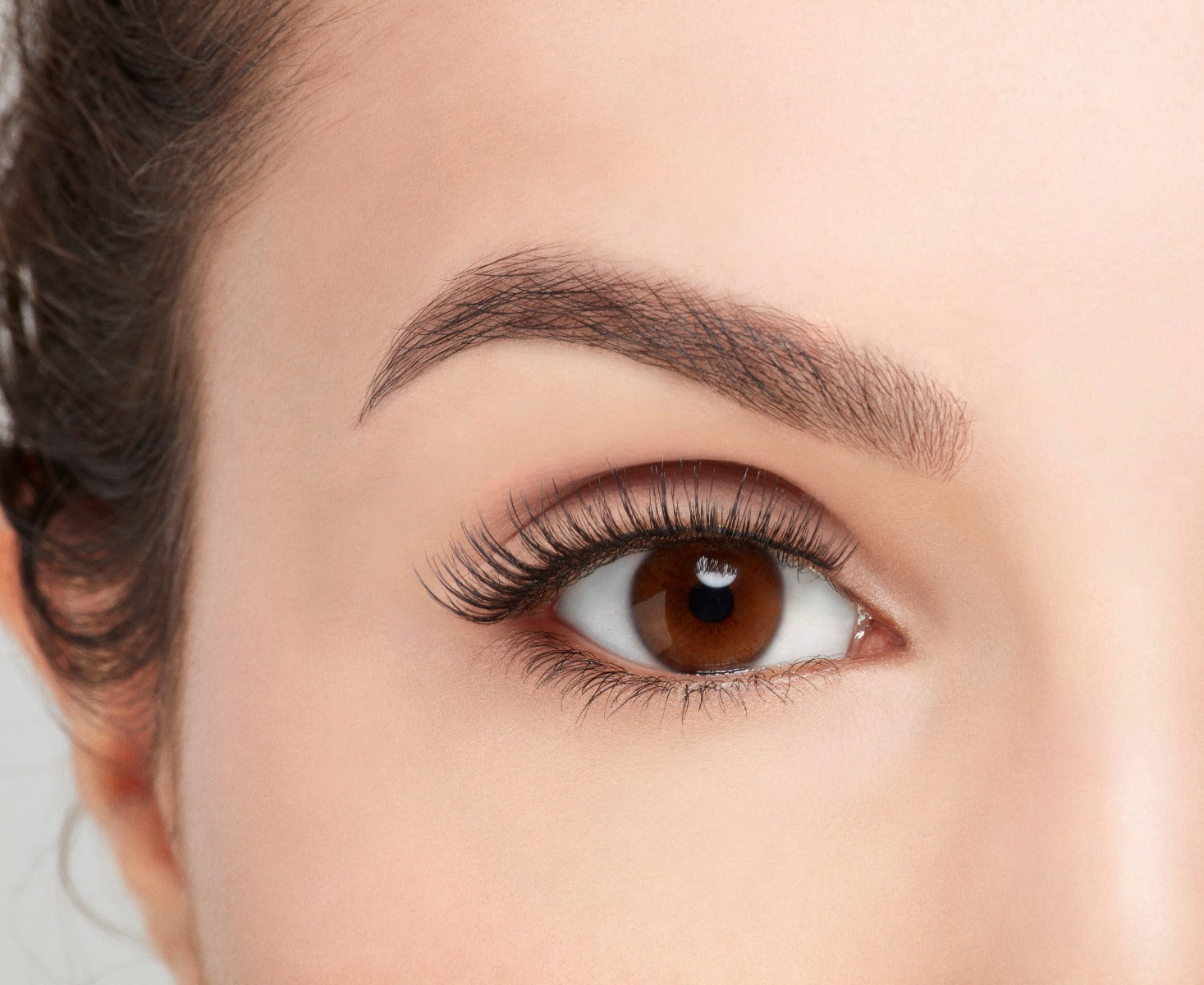 Frontage look of a model's zoomed right eye wearing an Ardell Natural 174 false lashes