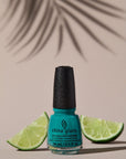 Wide-view of China Glaze Head to Moji-Toes nail color container with ripe citrus behind