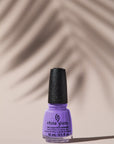 Expansive view of a colorant for a nail with leaf shadow as background