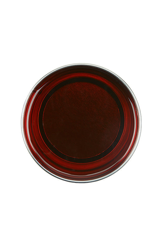 Top view of an open 14 ounce can of GiGi All Purpose Honee Soft showing its deep translucent brown color
