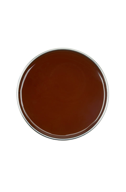 Top view of GiGi Brazilian Hard Body Wax without its lid showing its deep honey color