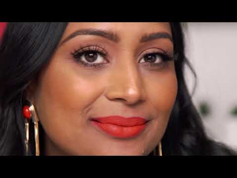 Woman with bold red lipstick wearing Ardell lashes for a glamorous eye look.