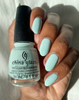 A woman's hand with a glance of 14ml China Glaze nail lacquer with hardeners in Live in the mo-mint color shade