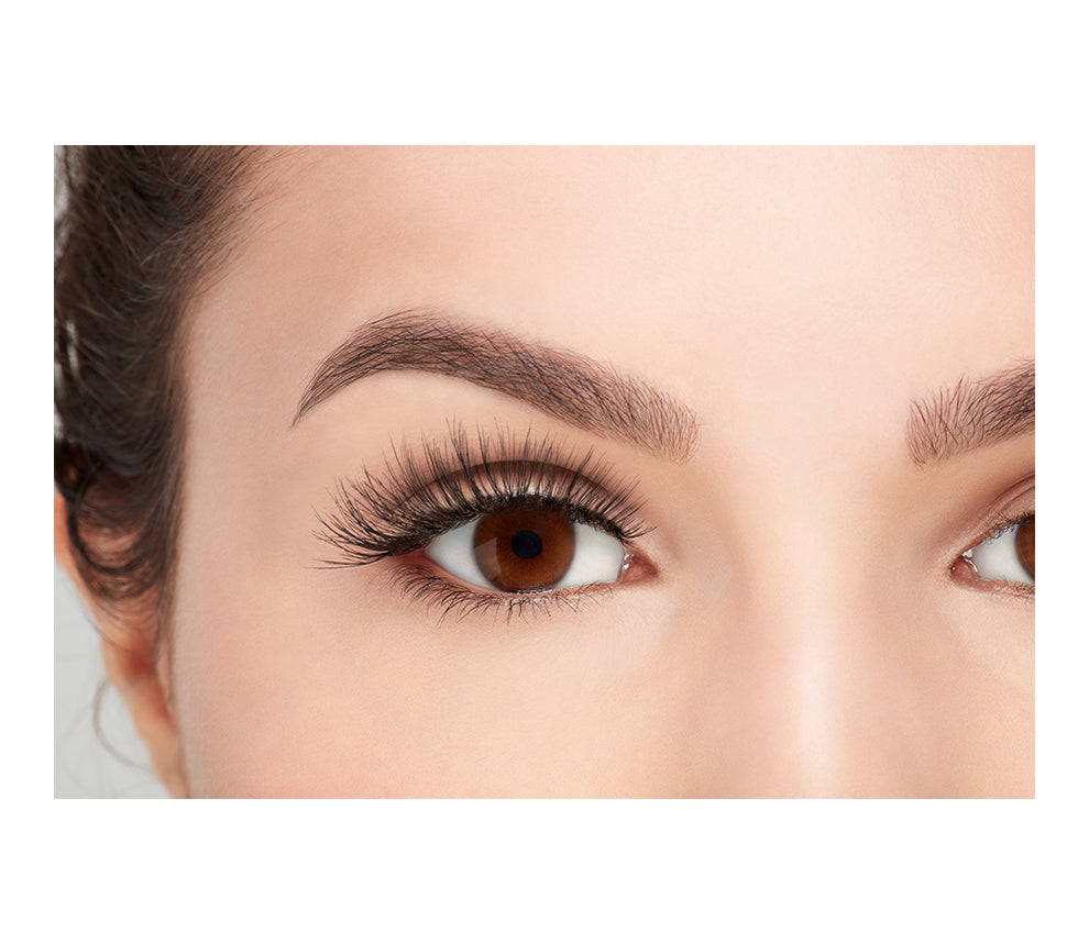 A model with an open right eye wearing Ardel Double Wispies showing how it looks like when wearing