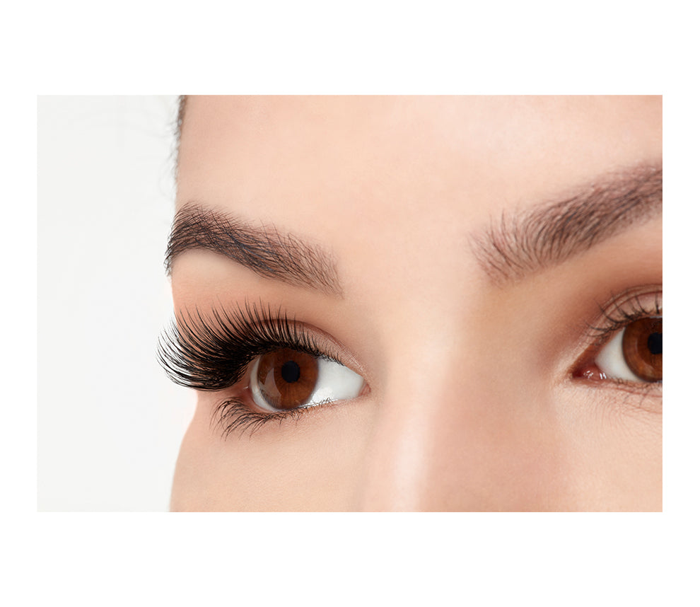 An extreme side close up shot of an eye wearing a Fauxmink 811 by Ardell creating a natural eyelash look