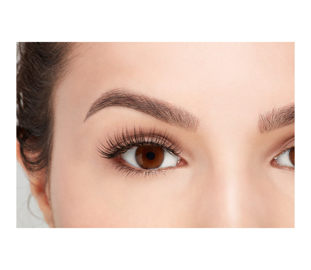 A model wearing Ardell's Faux mink 812 with open right eye showing its flared, winged-out & natural lash look