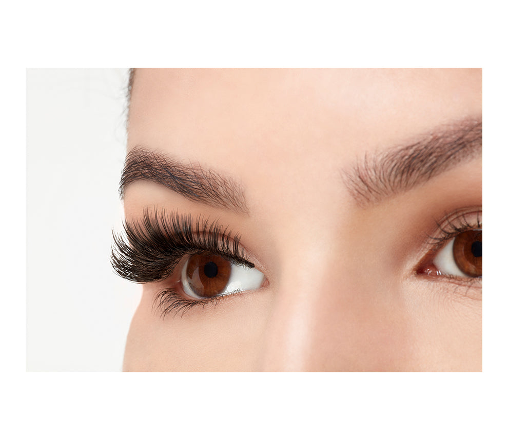 An extreme side close up shot of an eye wearing a Fauxmink 852 by Ardell creating a natural eyelash look