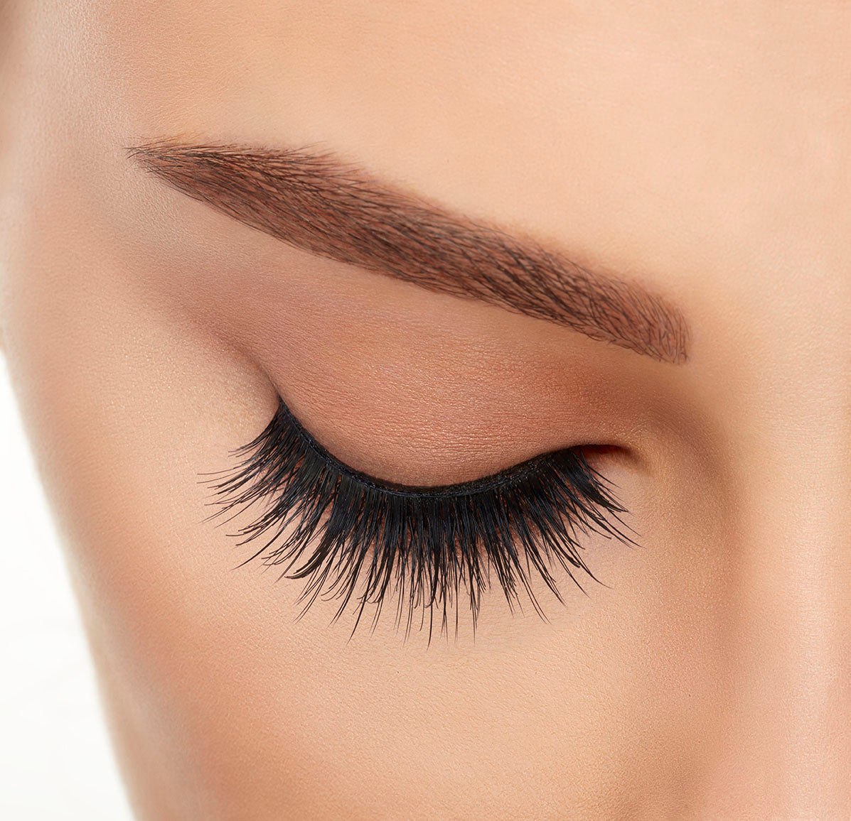 A model wearing Ardell&#39;s Double Up 207 with close right eye showing its extra-long layers with intense volume &amp; fullness lash