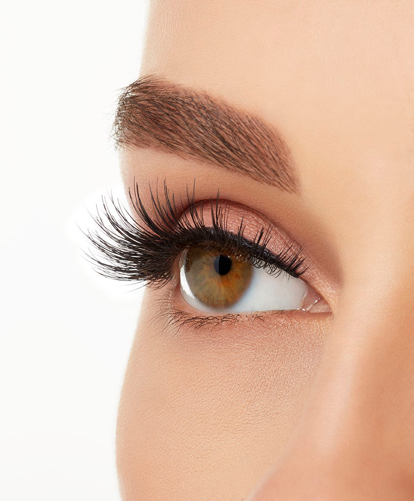 An extreme side close up shot of a model&#39;s eye wearing Ardell Double Up 207 creating natural, flared eyelash