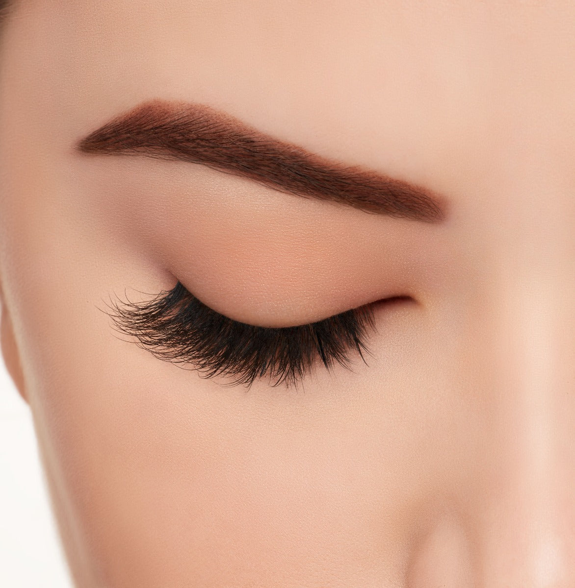 Closer look of a model's closed right eye wearing Ardell Mega Volume 260 false lashes