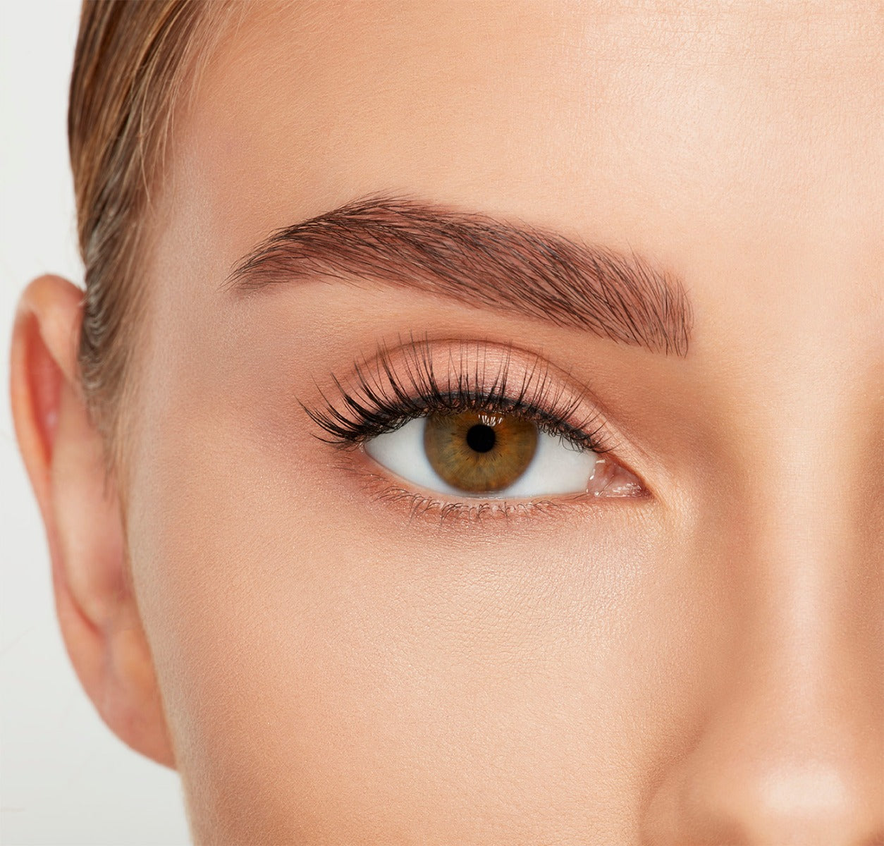 Close-up of a model&#39;s open right eye wearing an Ardell Lift Effect 744 false lash showing its airy elongated style
