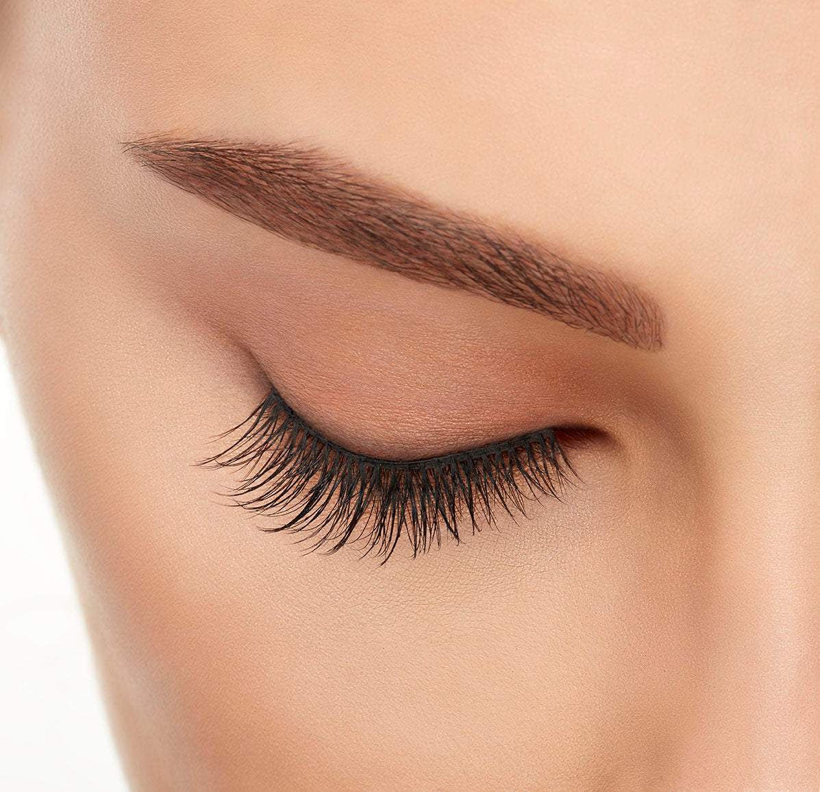 Close-up of a model&#39;s closed right eye wearing an Ardell Lift Effect 744 faux lash