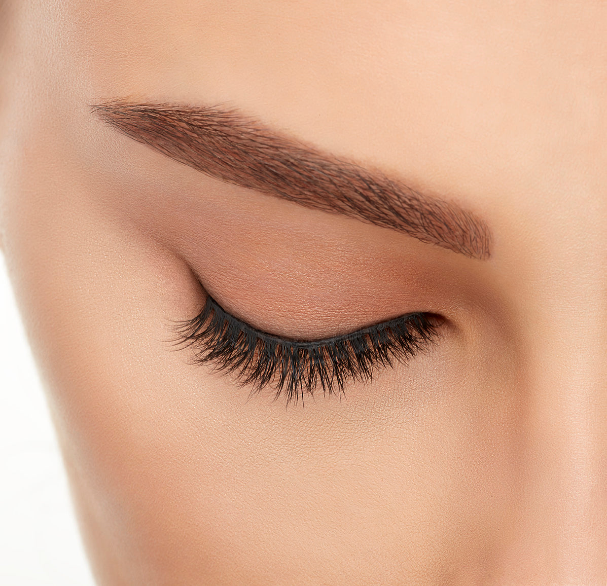 Close-up of a model&#39;s closed right eye wearing an Ardell Lift Effect 745 faux lash