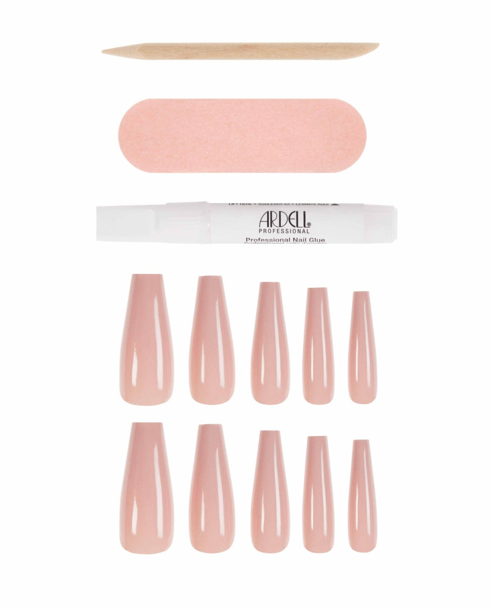 Sleek, glossy nude pink coffin-shaped press-on nails set with nail glue, file, and cuticle stick.
