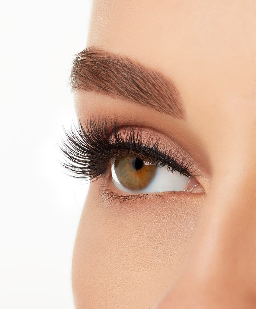 Angled close-up of a model's open right eye wearing an Ardell Mega Volume 252 faux lash